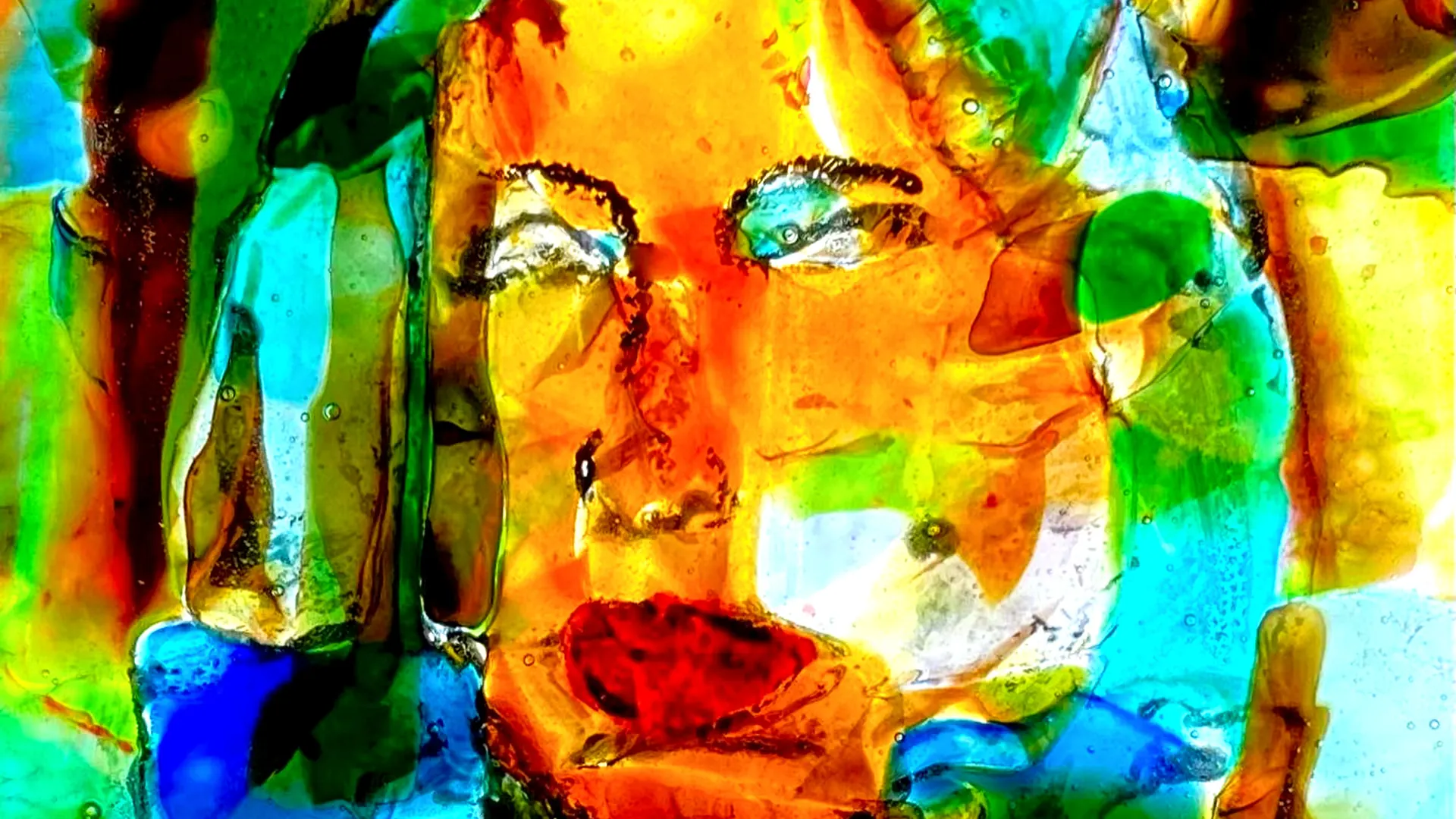 A fused glass panel by Mitch Bedke, lit from behind.